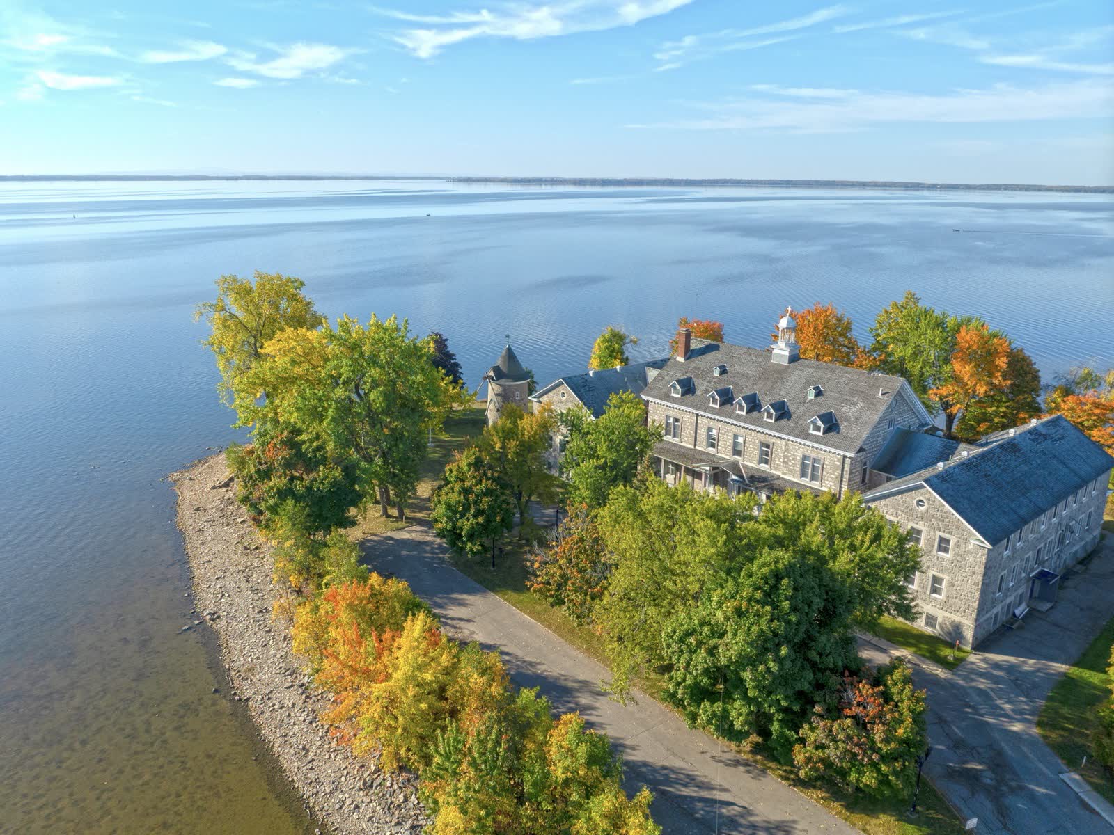 Heritage manor on the riverbank photographed by drone in autumn